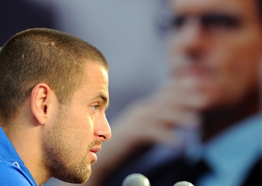 Joe Cole with an image of Capello looking over him Joe Cole with an image of Capello looking over him